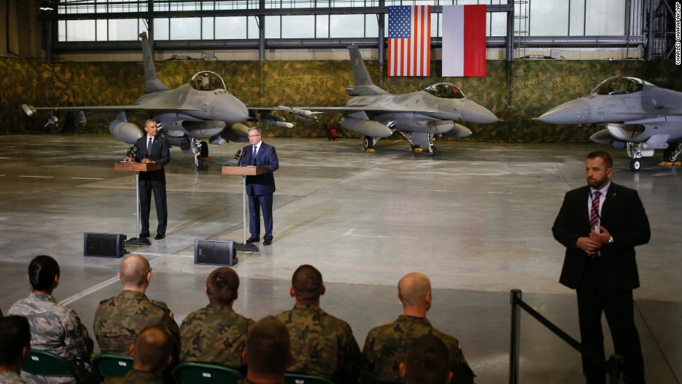 A Polish security official, right, stands watch as Obama and Komorowski make statements after meeting U.S. and Polish troops at an event in Warsaw on June 3. The main focus of Obama&#39;s Poland visit comes Wednesday, June 4, when he will give a speech  25 years after the nation&#39;s historic elections of 1989.