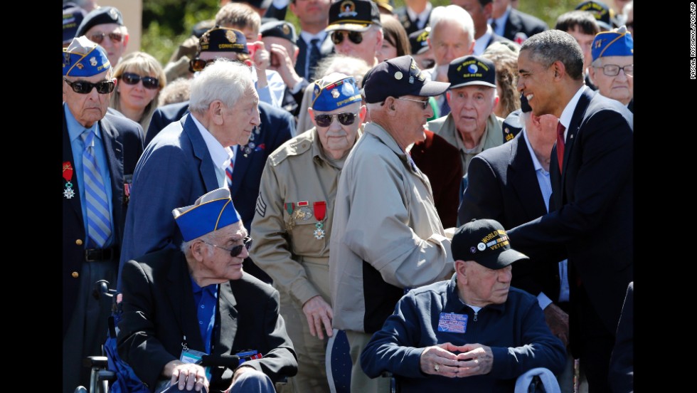 President Obama greets veterans during the D-Day ceremony in Colleville-sur-Mer.