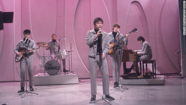 1966:  Full-length view of the British rock group The Animals, wearing matching checkered coats and black turtlenecks, performing on the set of a television program with a lavender backdrop. Lead singer Eric Burdon stands in the forefront.  (Photo by Hulton Archive/Getty Images)