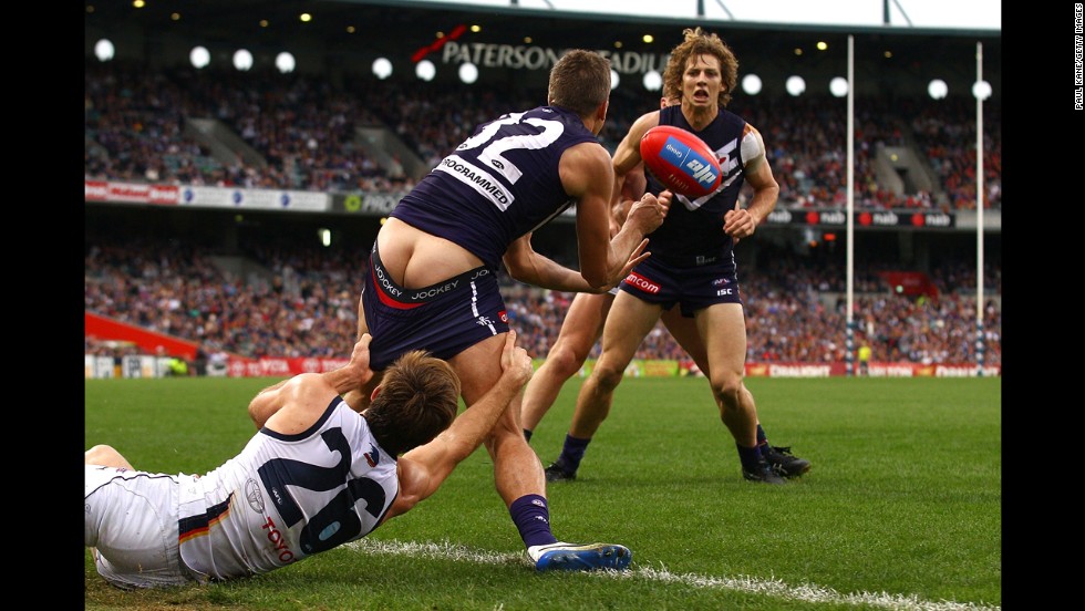 Richard Douglas of the Adelaide Crows tries to tackle Stephen Hill of the Fremantle Dockers during an Australian Football League match Sunday, June 8, in Perth, Australia.