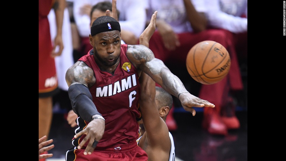 LeBron James passes the ball to a Miami Heat teammate during Game 1 of the NBA Finals on Thursday, June 5. James struggled with cramps after the air conditioning broke inside San Antonio&#39;s AT&amp;amp;T Center. The Heat ended up losing the game 110-95.