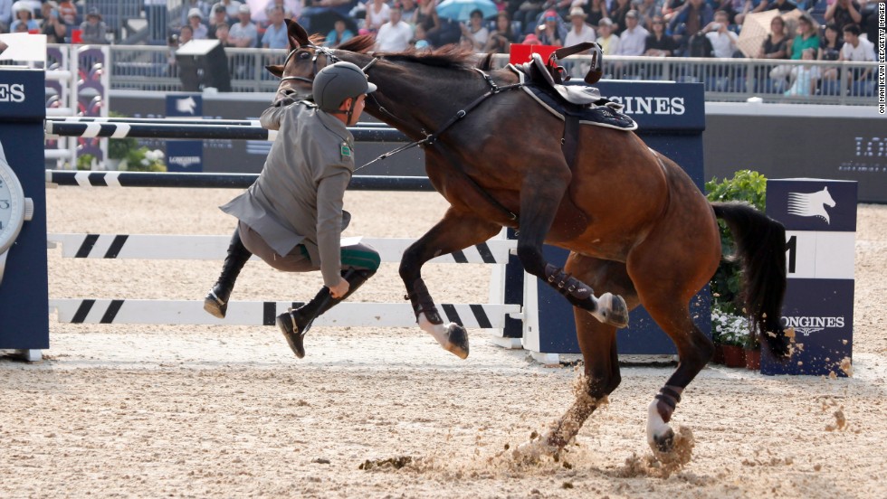 Show jumper Emanuele Gaudiano struggles with his horse, Cocoshynsky, during a Longines Global Champions Tour event in Shanghai, China, on Thursday, June 5.