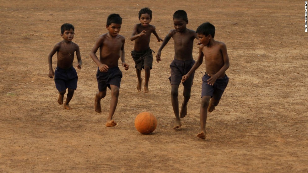 Children play soccer on a playground in Bhubaneswar, India, on Sunday, June 8.