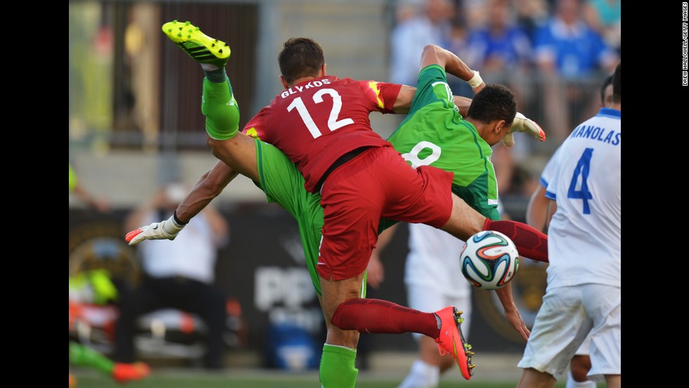 Greece goalkeeper Panagiotis Glykos gets tangled up with Nigeria forward Peter Odemwingie during an international friendly match Tuesday, June 3, in Chester, Pennsylvania. The game, a World Cup warm-up for both teams, finished 0-0.