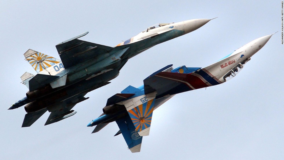 A Russian Air Force flight demonstration team performs with their Su-27 jet fighters over St. Petersburg, Russia. An Su-27 &quot;showed its belly&quot; to a U.S. reconnaissance jet in April 2014.