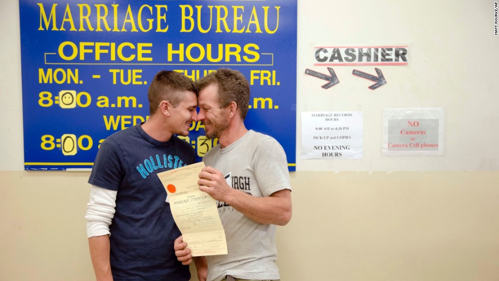 William Roletter, left, and Paul Rowe get close after having their photo taken with their marriage certificate May 21, 2014, at Philadelphia City Hall.