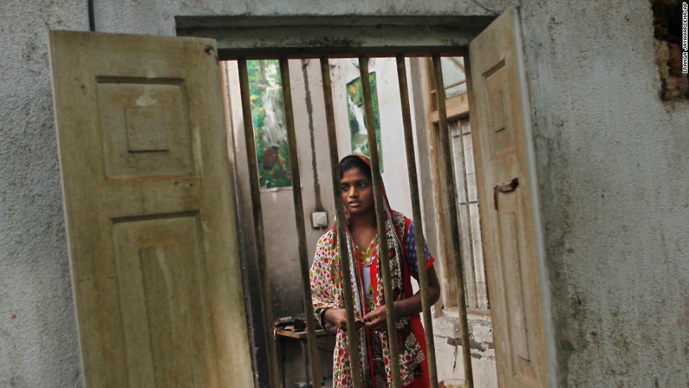 Shifna Abdul Kareem, a 16-year-old Muslim, surveys the damage to her burnt house in Adhikarigoda, a village in Aluthgama, following an outbreak of violence.