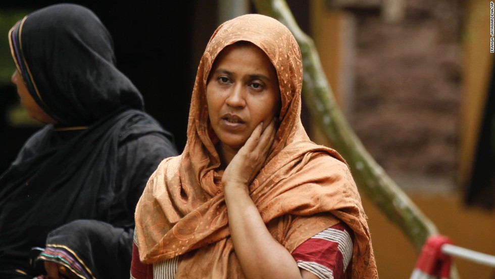 A Muslim woman observes her vandalized house in Aluthgama.