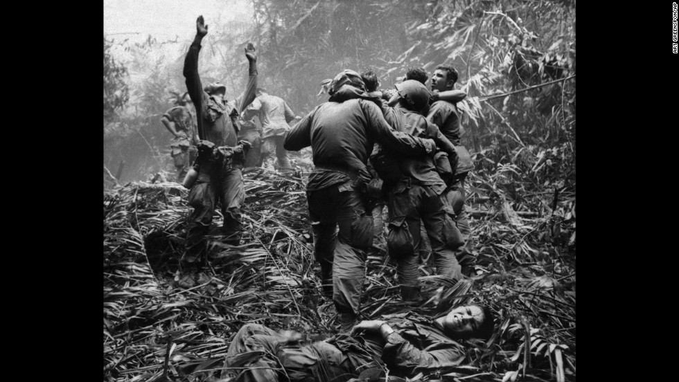 Associated Press photographer Art Greenspon captured this photo of  soldiers aiding wounded comrades. The first sergeant of A Company, 101st Airborne Division, guided a medevac helicopter through the jungle to retrieve casualties near Hue in April 1968. 