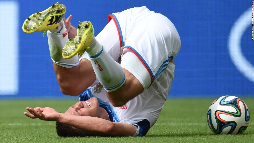 Russia&#39;s forward Maxim Kanunnikov tumbles.