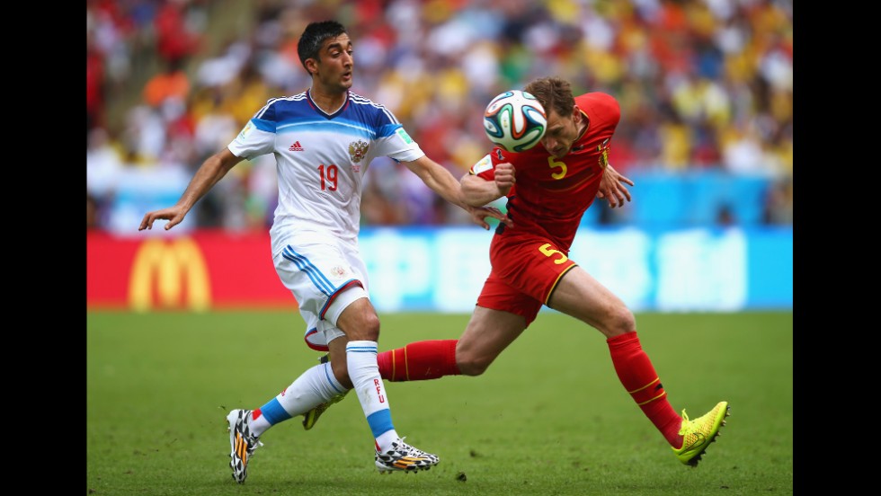 Jan Vertonghen of Belgium and Alexander Samedov of Russia compete for the ball. &lt;a href=&quot;http://www.cnn.com/2014/06/21/football/gallery/world-cup-0621/index.html&quot;&gt;See the best World Cup photos from June 21.&lt;/a&gt;