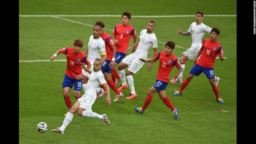 Algerian midfielder Nabil Bentaleb, second left, competes for the ball with South Korean midfielder Ki Sung-yueng, first left, on June 22.