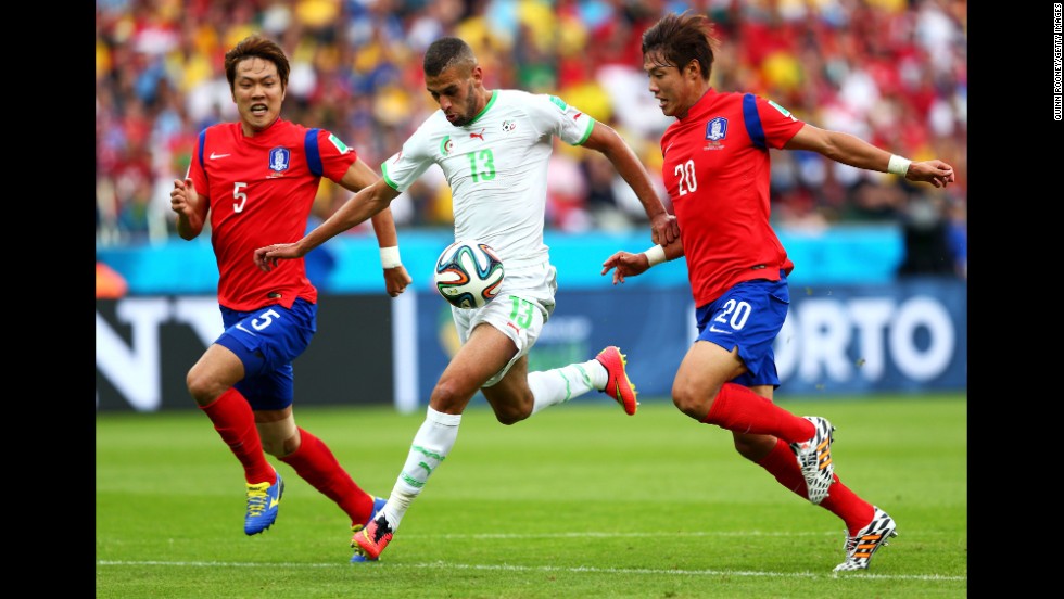 Islam Slimani of Algeria breaks through South Korean defenses on his way to scoring his team&#39;s first goal.