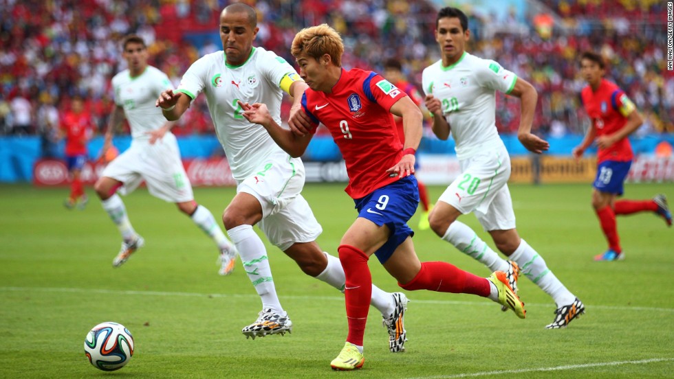 Son Heung-min of South Korea controls the ball against Madjid Bougherra of Algeria.