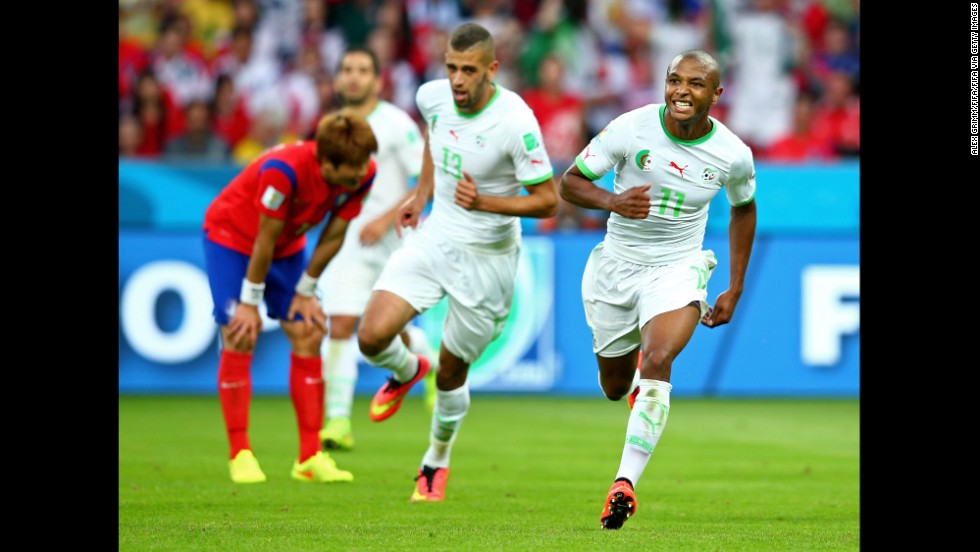 Yacine Brahimi of Algeria, right, celebrates scoring his team&#39;s fourth goal during a World Cup game against South Korea at Beira-Rio Stadium in Porto Alegre, Brazil. Algeria won 4-2, its first World Cup victory in 32 years.