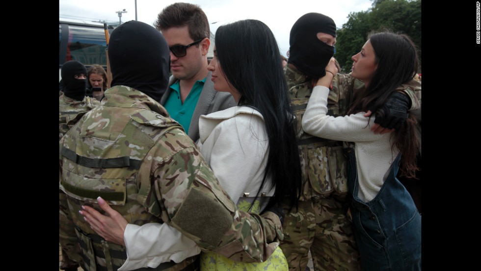 People say goodbye to volunteer soldiers in Kiev, Ukraine, before they leave for the eastern part of the country to join the ranks of a special battalion on Monday, June 23. 