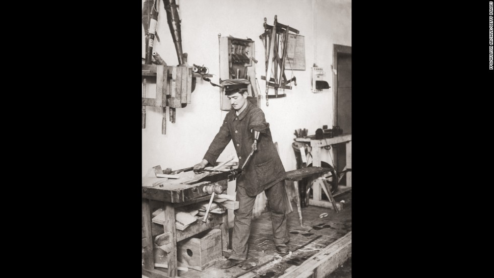 A disabled German ex-serviceman works as a carpenter with the aid of a prosthetic arm, Germany, circa 1919.