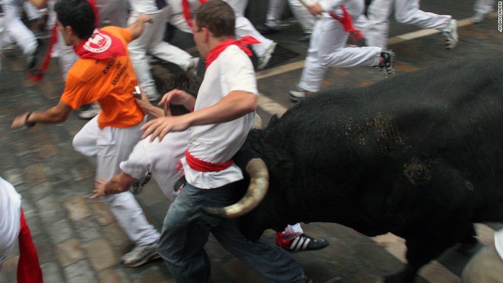 A young man is caught between the bull&#39;s horns as he is tossed on July 8, 2007 in the old city streets of Pamplona. Thousands of &quot;runners&quot; test their skill, courage, and luck in the 900-meter course made famous by Ernest Hemingway&#39;s 1926 novel &quot;The Sun Also Rises,&quot; first published in 1926. The man was thrown against a fence but not injured. These images by photographer Jim Hollander appear in a new book &quot;&lt;a href=&quot;http://www.thebullsofpamplona.com&quot; target=&quot;_blank&quot;&gt;Fiesta: How To Survive The Bulls Of Pamplona&lt;/a&gt;.&quot;