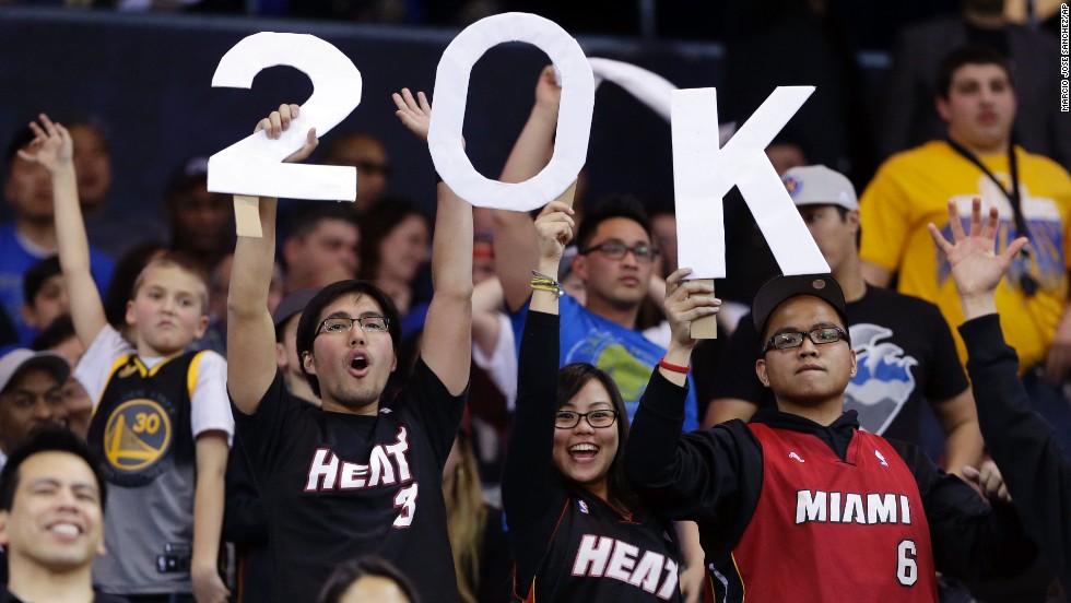 Fans hold a sign commemorating James&#39; 20,000th career point, which he scored in January 2013 against the Golden State Warriors in Oakland, California.