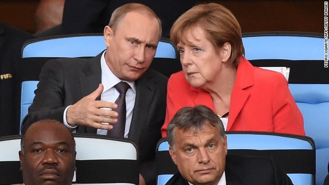 German Chancellor Angela Merkel (top R) and Russian President Vladimir Putin chat  during the 2014 FIFA World Cup final.