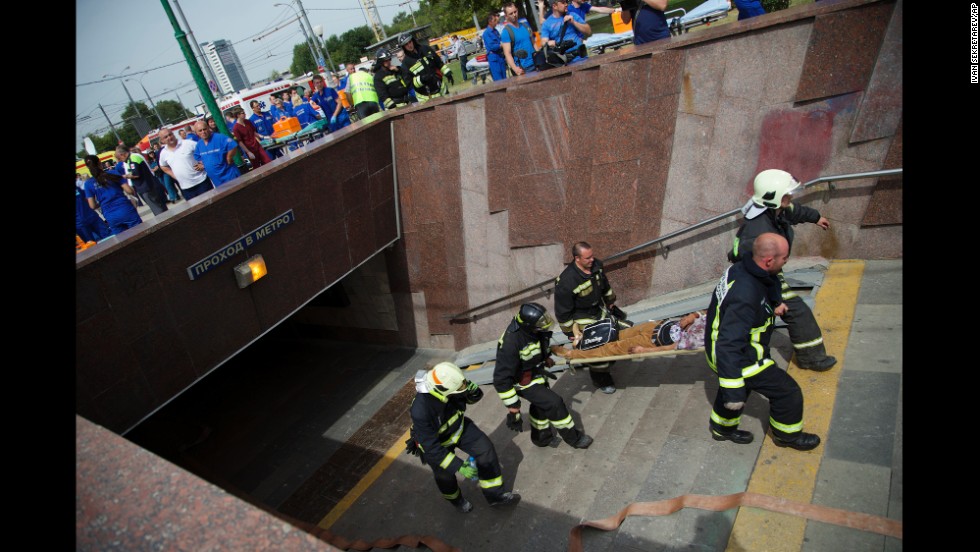 Paramedics and firefighters carry an injured man after a metro train derailed in Moscow on Tuesday, July 15. It was not immediately clear what caused the derailment, which took place during morning rush hour in the Russian capital.