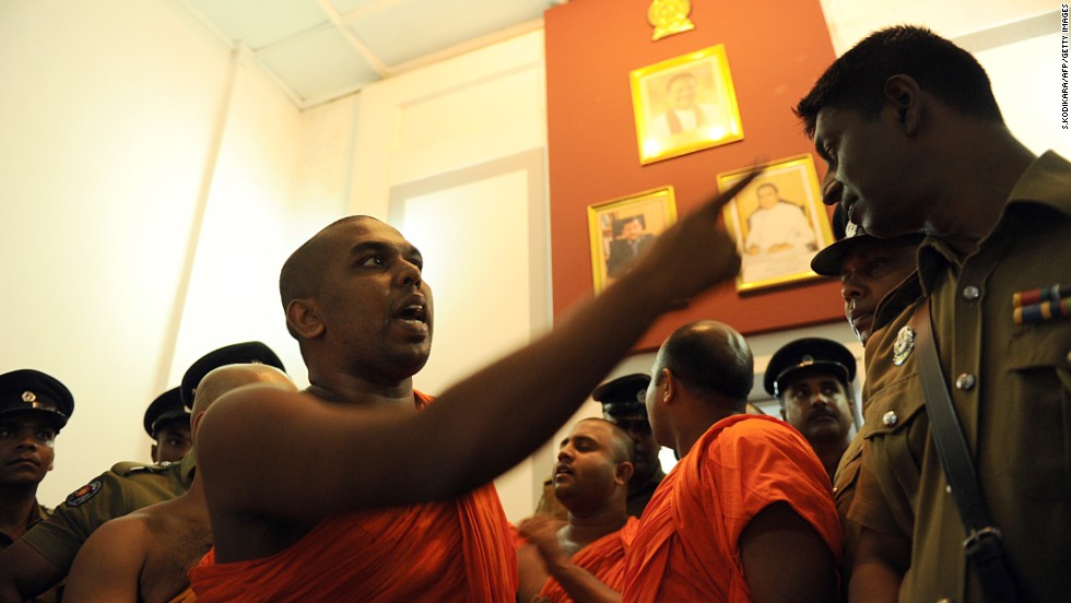 A monk belonging to the group debates with a police officer at the Trade Ministry in Colombo in April.