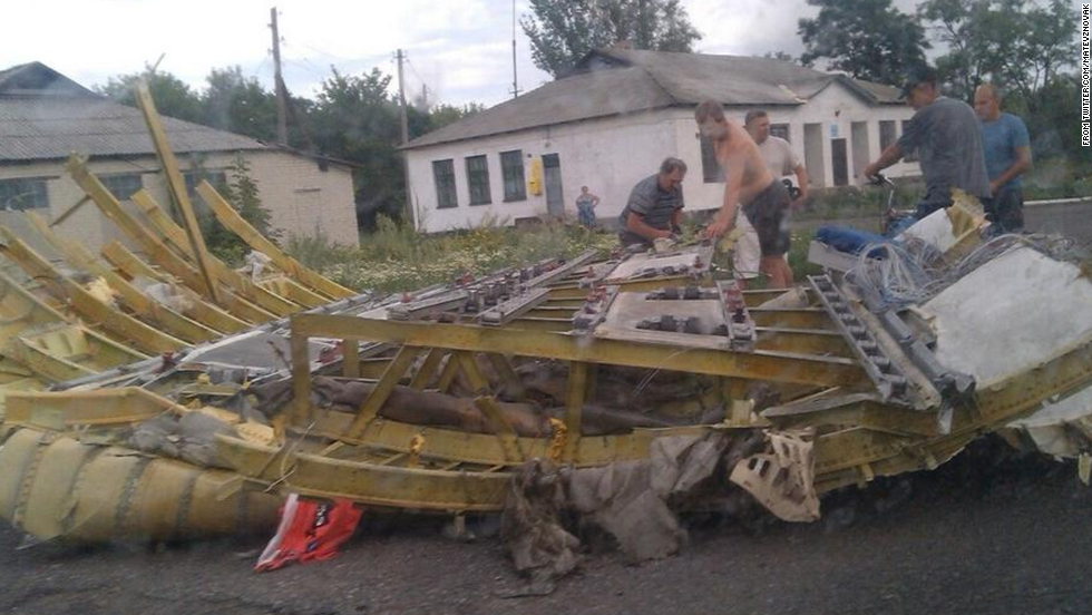 People inspect a piece of wreckage believed to be from Malaysia Airlines Flight 17. This image was posted to &lt;a href=&quot;https://twitter.com/MatevzNovak&quot; target=&quot;_blank&quot;&gt;Twitter&lt;/a&gt;.