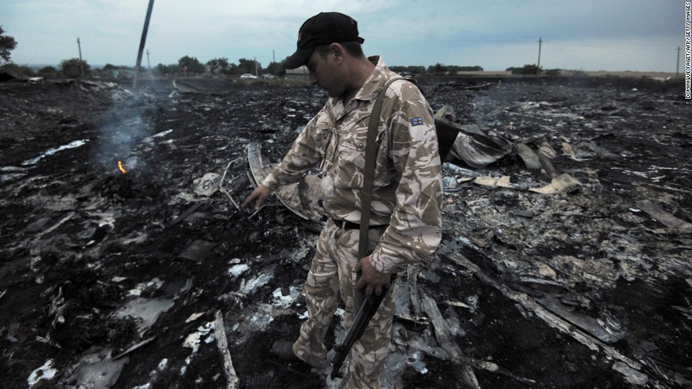 A man inspects debris from the plane.