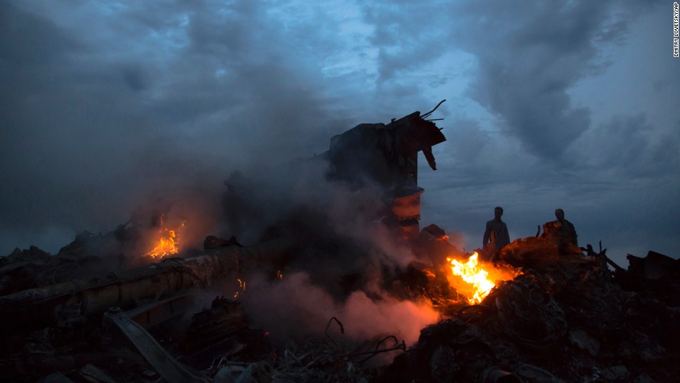 People walk amid the debris at the site of the crash.