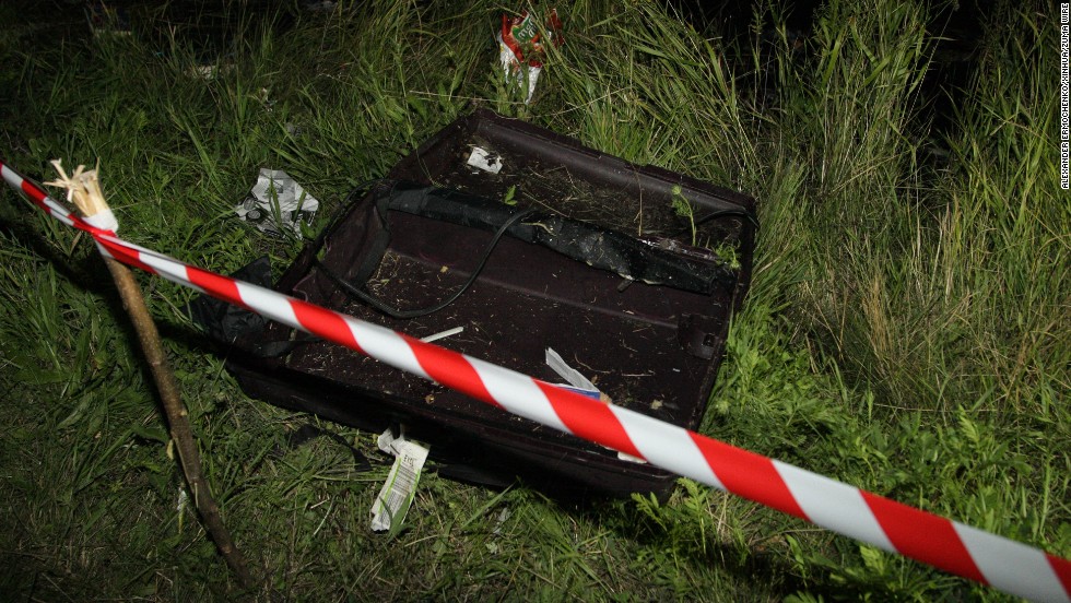 An empty suitcase is cordoned off near the plane&#39;s impact site on Thursday, July 17.