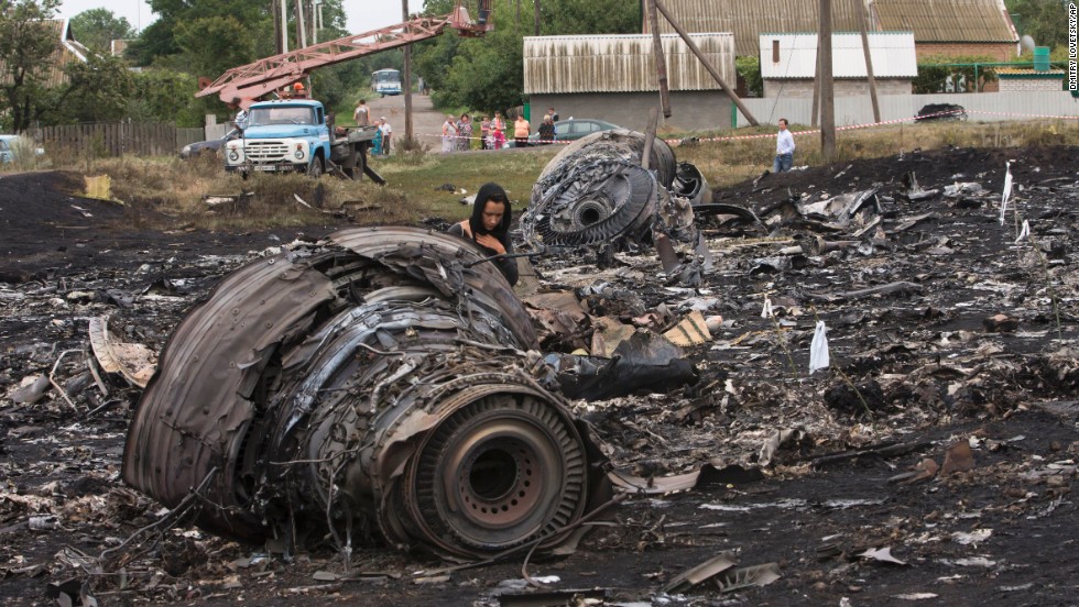 A woman walks through the debris field on July 18, 2014. 