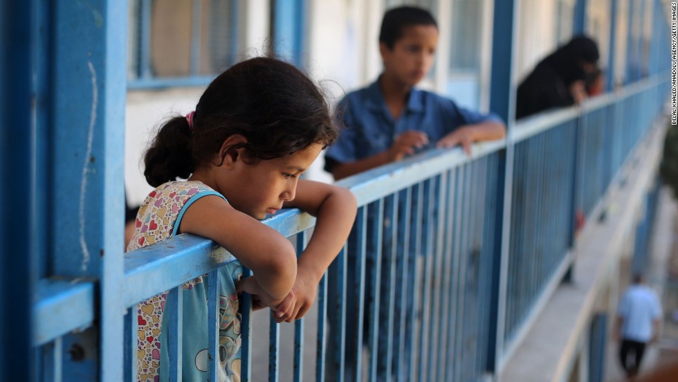 Children stare as Palestinians flee Khan Yunis, Gaza, to safe areas July 18.