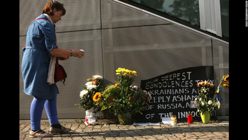 A woman in Berlin places a candle at a memorial on July 18. 