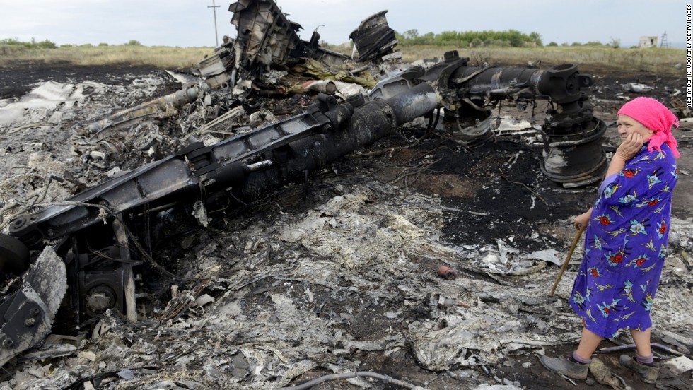 A woman looks at wreckage on July 19, 2014.