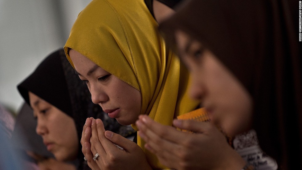 Friends of Nur Shazana Mohamed, a crew member aboard the flight, take part in a special remembrance prayer at a mosque in Putrajaya, Malaysia, on July 19. 