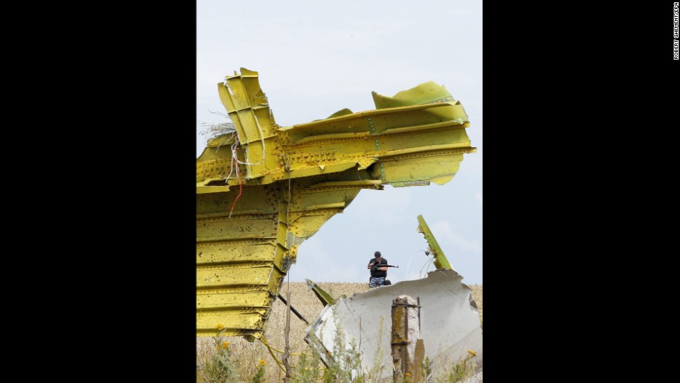 A large piece of the main cabin is under guard at the crash site on July 19, 2014. 