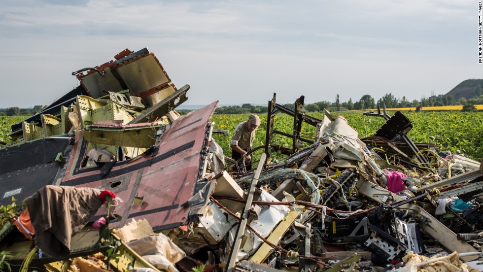 A man looks through the debris at the crash site on July 19, 2014. 