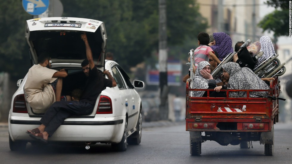 Palestinians flee their homes as Israeli troops focus their firepower on the Gaza town of Shaja&#39;ia on Sunday, July 20. The shelling and bombing killed at least 60 people and wounded 300, according to the Gaza Health Ministry.