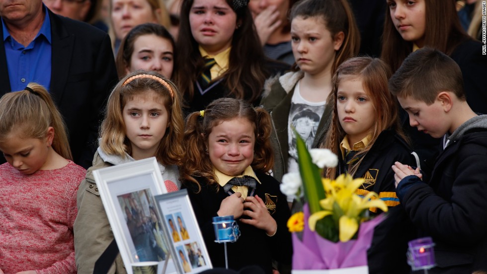 Mourners in Eynesbury, Australia, attend a memorial service Sunday, July 20, for a family of five killed in the disaster.