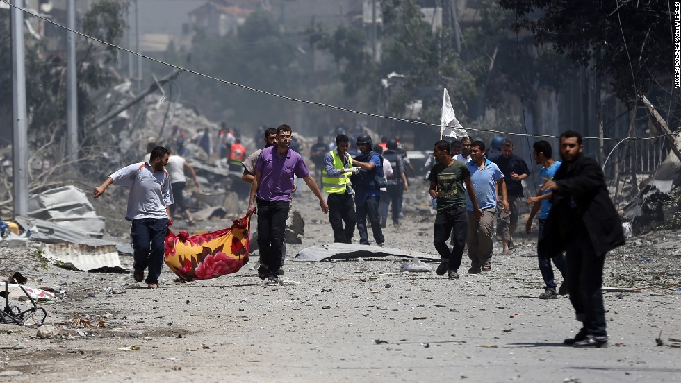 Palestinian medics carry a body in Gaza&#39;s Shaja&#39;ia district on July 20.