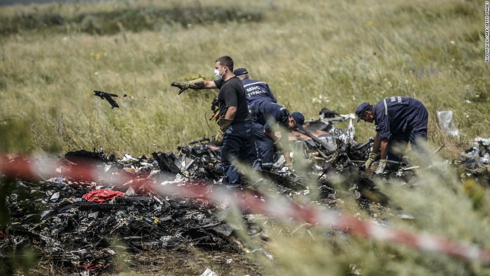 Ukrainian State Emergency Service employees sort through debris on July 20, 2014, as they work to locate the deceased.
