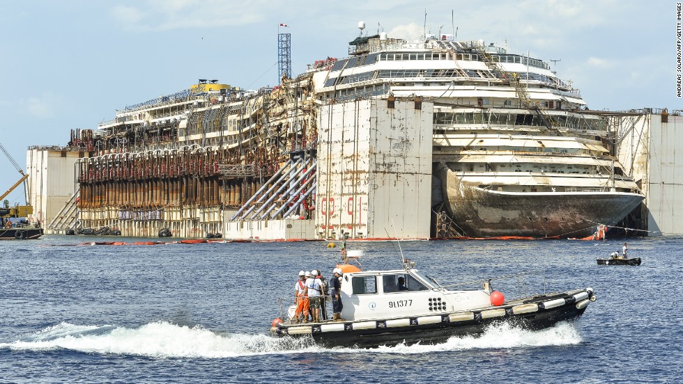 The Costa Concordia cruise ship sits in front of the harbor of Giglio Island after it was refloated using air tanks attached to its sides on Tuesday, July 22.  Environmental concerns prompted the decision to undertake the expensive and difficult process of refloating the ship rather than taking it apart on site.