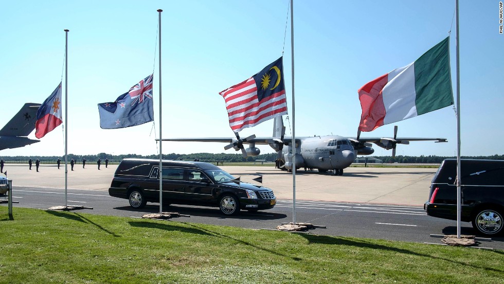 Flags fly at half-staff as hearses pass by in Eindhoven on July 23.