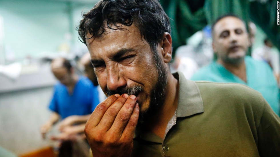 A Palestinian man cries after bringing a child to the Kamal Adwan hospital in Beit Lahiya on Thursday, July 24. The child was wounded in &lt;a href=&quot;http://www.cnn.com/2014/07/24/world/meast/mideast-crisis/index.html&quot;&gt;a strike on a school&lt;/a&gt; that was serving as a shelter for families in Gaza. It&#39;s unclear who was behind the strike. The Israeli military said it was &quot;reviewing&quot; the incident, telling CNN that a rocket fired from Gaza could have been responsible.