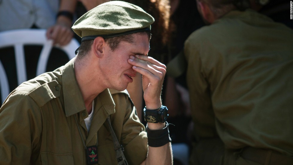 An Israeli soldier mourns at the grave of reserve Master Sgt. Yair Ashkenazy during his funeral at the military cemetery in Rehovot, Israel, on Friday, July 25. Ashkenazy was killed during operations in northern Gaza, the Israel Defense Forces reported.
