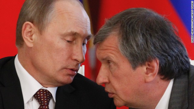 Russia&#39;s President Vladimir Putin talks to Rosneft President Igor Sechin in Moscow in 2013.