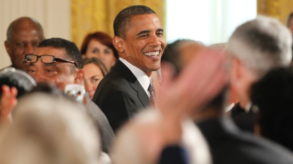 President Barack Obama reacts as the audience sings 