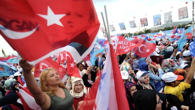 Supporters of Recep Tayyip Erdogan wave Turkish flags during a rally on August 3, 2014 in Istanbul.