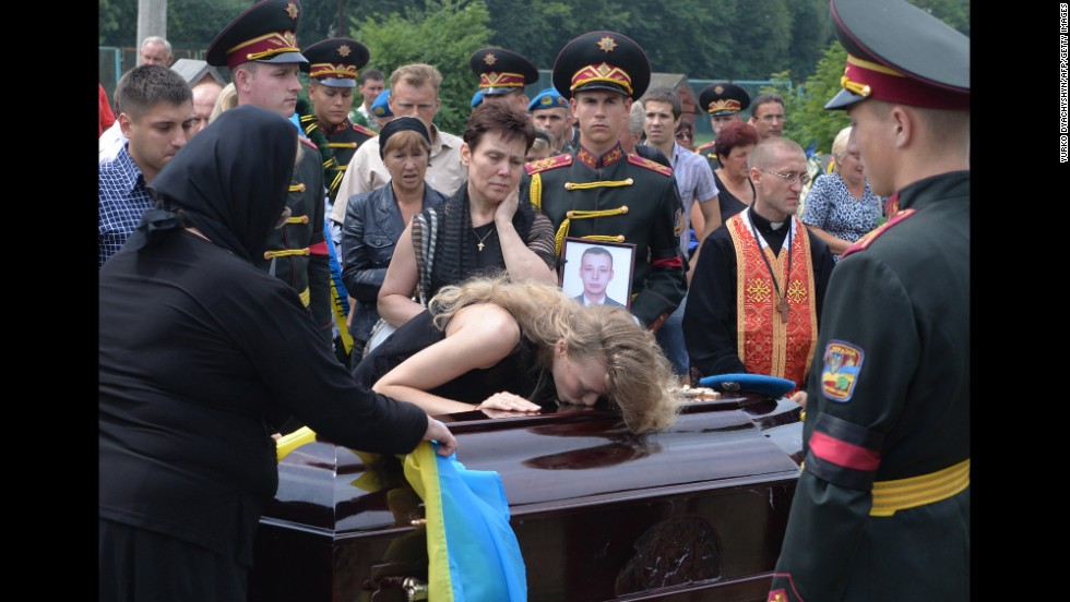 Relatives of Ukrainian military member Kyril Andrienko, who died in combat in eastern Ukraine, gather during his funeral in Lviv, Ukraine, on August 7.