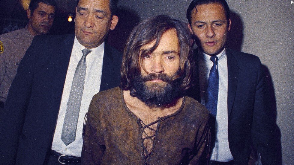 Manson is escorted to his arraignment on conspiracy-murder charges.